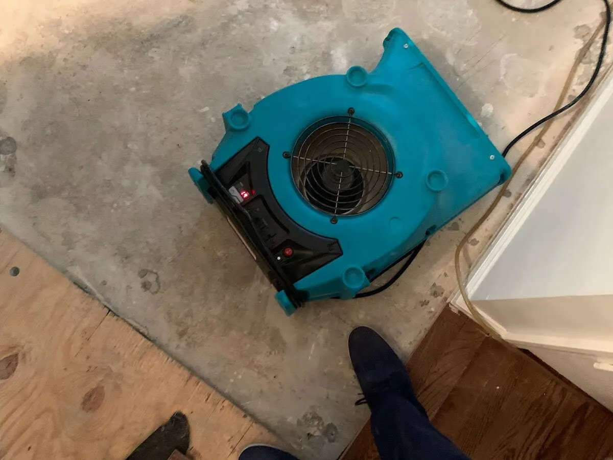 Air mover drying subfloor during Commercial Water Damage Restoration in Airmont